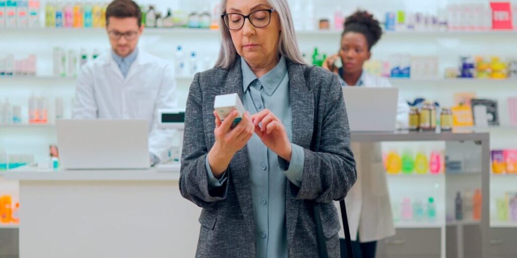 Does CBD Oil Expire Or Go Bad? Tips For Making CBD Last Longer Senior woman checking to see the CBD expiration date on a box before buying.